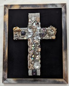 an ornate cross is displayed in a frame