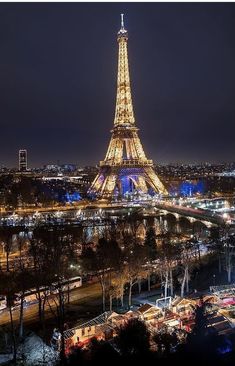 the eiffel tower lit up at night with lights on it's sides