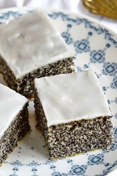 four pieces of cake sitting on top of a blue and white plate