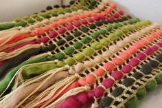 multicolored rug with tassels laying on top of each other