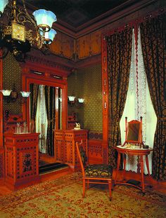 an ornately decorated bedroom with antique furniture