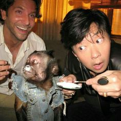 two men are eating food with an animal on the plate