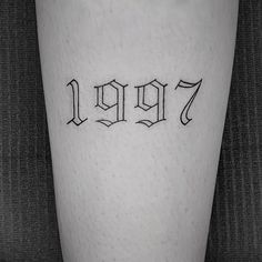 a person with a tattoo on their leg that reads,'1917'in cursive letters