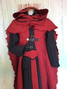 a red and black medieval costume on display