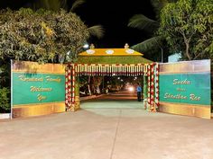 an entrance to a resort at night time