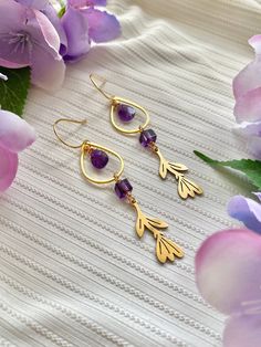 Garden inspired gold dangle earrings featuring brass crocus charms and deep purple amethyst gemstones Stones~ ✧ faceted amethyst teardrops ✧ cube-shaped amethyst Metals~ ✧ brass & gold plated These earrings hang from gold plated hypoallergenic ear wires Approximate measurements~ Length: 2.75" (7 cm) Width: 0.6" (1.5 cm) Each pair of earrings are lovingly handmade and will vary slightly ♡ Amethyst Flower, Wire Wrapped Crystal, Flower Drop Earrings, Wrapped Crystal, Drop Earrings Gold, Amethyst Gold, Wire Wrapping Crystals, Teardrop Dangle Earrings, Garden Inspired