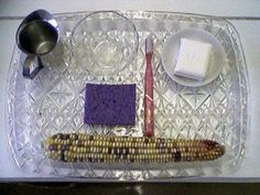 a tray with corn, butter, and other items on it that are ready to be eaten