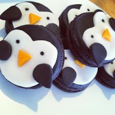 some cupcakes with penguins on top of them