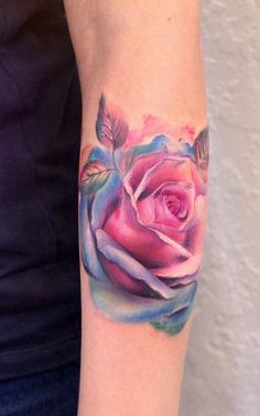 a woman's arm with a rose tattoo on it