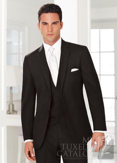 a man in a black suit and white shirt