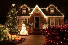 christmas lights decorate the front of a house