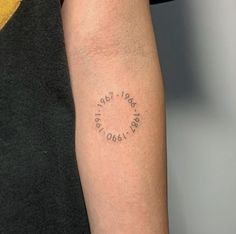 a person with a tattoo on their arm that says, love is in the air