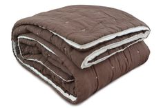 the comforter is brown and has white piping on it's sides, along with two matching pillows