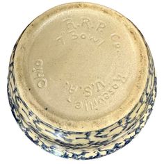 a blue and white ceramic bowl with writing on the bottom, sitting in front of a white background