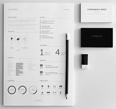 a black and white minimalistic resume on top of a piece of paper next to a pen