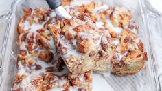 a close up of a plate of food with cinnamon rolls and icing on it