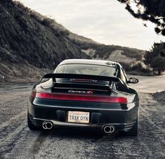 a black sports car parked on the side of a road