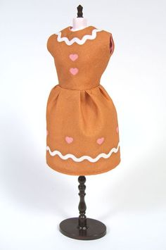 a brown dress with pink hearts on it