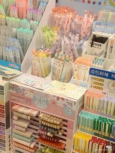 an assortment of different colored toothbrushes and other items in a display case at a store