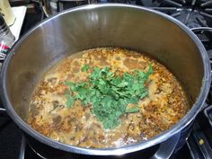 a pot filled with food sitting on top of a stove