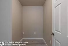 an empty hallway leading to another room with white doors and wood flooring on both sides