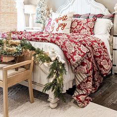 a bedroom decorated for christmas with red and white bedding