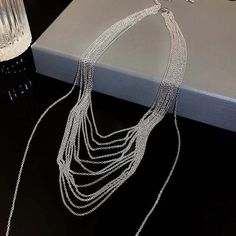 ✦ Transform your wardrobe with this Multistrand Silver Tassel Chain Necklace. Accessorize with this elegant yet simple piece for a bold and daring look. Perfect for a night out, this necklace will take your outfit to the next level. Despite the absence of diamonds, this eye-catching piece will make you shine at any party! ----------- DETAILS ----------- - Color: Silver - Materials: Brass - Necklace Length: 42.3cm - SKU: HN2699 Elegant Silver Chain Necklace For Fashion, Modern Choker With Adjustable Chain For Parties, Trendy Silver Chain Necklace For Formal Occasions, Minimalist Silver Chain Necklace For Party, Modern Adjustable Chain Choker For Parties, Trendy Silver Choker For Formal Occasions, Metal Clavicle Chain Drop Necklace For Party, Modern Party Choker With Adjustable Chain, Elegant Silver Chain Necklace For Party