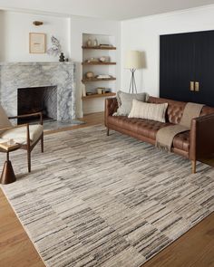 a living room filled with furniture and a fire place in the middle of the room