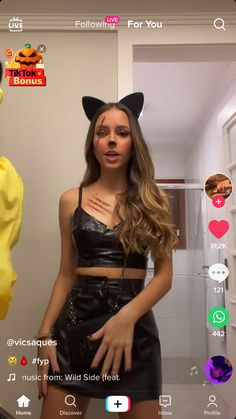 a girl in a cat costume is on the phone and she's making an angry face