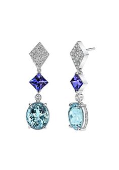 A exquisite pair of oval-cut Aquamarines, totaling 6.99 carats are the stars of these exuberant 18K white gold earrings. Joining the Aquamarines are two ravishing Tanzanites totaling 2.65 carats, encircled by numerous shimmering diamonds weighing a total of 1.06 carats. Tanzanite Earrings, Aqua Marine, White Gold Earrings, Princess Cut, Oval Cut, Aquamarine, Jewelry Earrings Dangle, Gold Earrings, Dangle Earrings