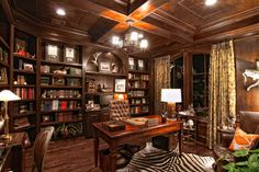 an elegant home office with zebra print rugs and wooden bookshelves on the wall