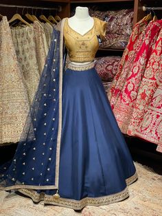 Navy blue gotta patti lace border skirt paired with contrasting gold thread embroidery ,zardozi and stone work blouse and net sequence dupatta. Fabric: Raw Silk This outfit can be customized in multiple colors and specific to client measurements. 90 days of production time is required and are for bulk orders only! Orders are processed in store only! Final fittings/alterations not included. Minimum Order Quantity- 4 pieces Blue Dola Silk Choli With Traditional Drape, Traditional Royal Blue Lehenga With Resham Embroidery, Blue Kundan Lehenga With Pallu, Bollywood Style Royal Blue Cutdana Sets, Royal Blue Choli With Zari Work, Blue Raw Silk Dupatta With Dori Work, Royal Blue Choli With Zari Work And Traditional Drape, Blue Dola Silk Anarkali Set With Sheer Dupatta, Designer Wear Royal Blue Choli With Traditional Drape