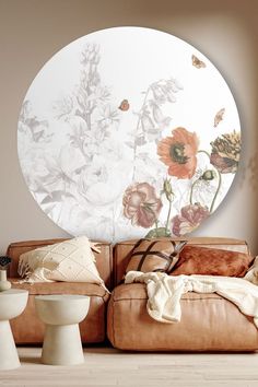 a living room filled with furniture and flowers on the wall