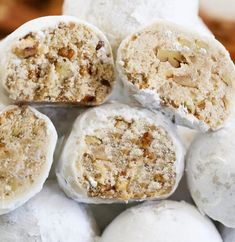 a pile of white balls with nuts on top