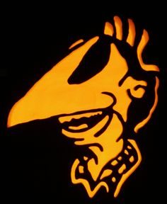 a carved pumpkin with a bird on it's face and the word, happy halloween