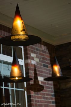 three witches hats hanging from the ceiling with text reading floating witch's hat luminaries