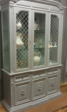 an antique china cabinet with glass doors