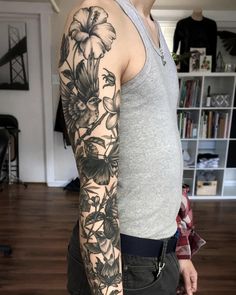 a man with a flower tattoo on his arm