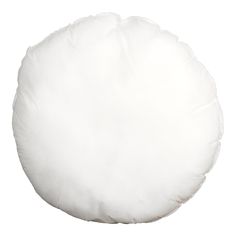 a white round pillow sitting on top of a table