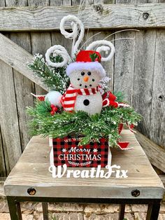 a snowman sitting on top of a wooden table