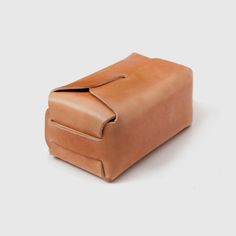 a tan leather bag on a white background