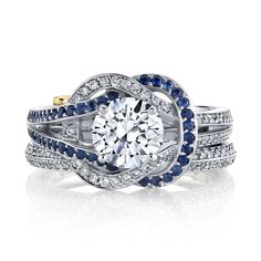 Talk about incredible. The Entangle engagement ring and matching wedding band add a pop of color to your wedding set with not only diamonds, but also blue sapphires, knotted together to create a very unique design. Keep in mind that we can customize this ring by setting a different color gemstone, depending upon what you prefer. Set with 49 diamonds (for a total weight of 0.245 carats) and 41 sapphires (for a total weight of 0.205 carats), this ring is not short on sparkle. The matching wedding