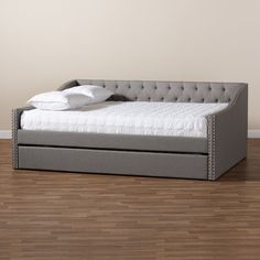 a bed that is sitting on top of a wooden floor