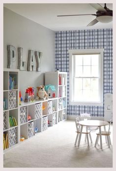 a child's playroom with toys and bookshelves