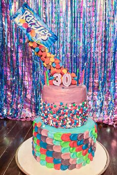 a birthday cake is decorated with candy and sprinkles