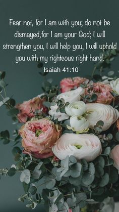 a vase filled with flowers and greenery next to a bible verse on the wall