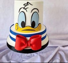 this is a cake with donald the duck on it's face and bow tie