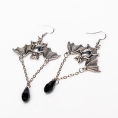 Unleash your inner darkness with these captivating Bat Earrings. Crafted from durable zinc alloy with a striking black finish, each earring measures 1.5 by 1 inch, featuring an elegant 1-inch chain adorned with a black diamond-shaped accent. Perfect for adding a touch of gothic charm to any outfit, these earrings are a must-have for your collection. Alternative Earrings, Inner Darkness, Alchemy Gothic, Bat Earrings, Dark Elegance, Earring Collection, Dark Gothic, Diamond Shaped, Earrings Collection