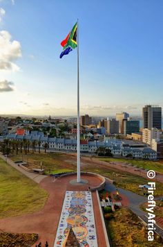 an aerial view of a flag pole with the city in the background