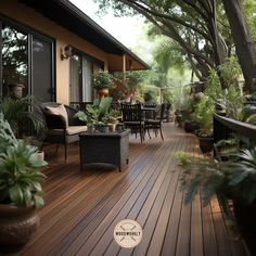 a deck with chairs, tables and potted plants on the top floor is surrounded by greenery